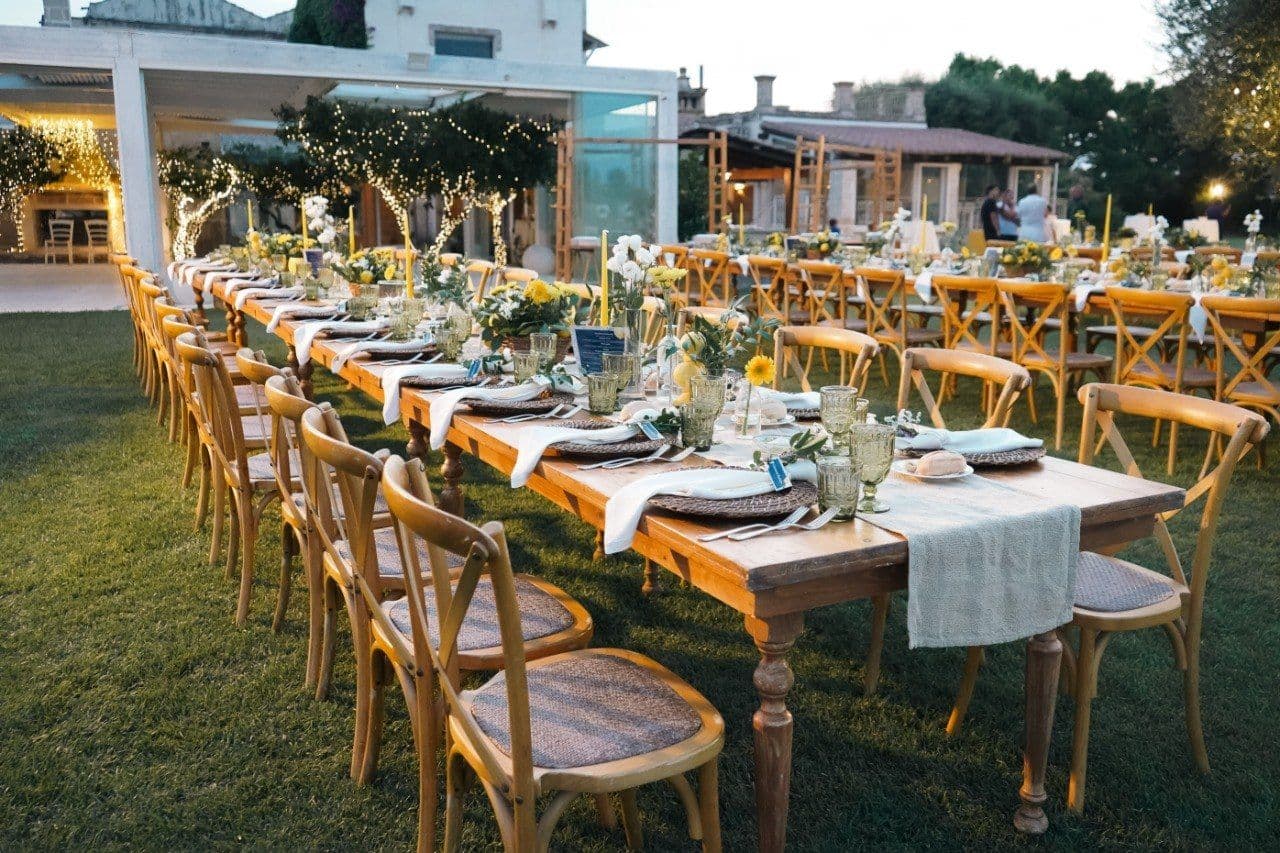 The long table in the courtyard, lit for dinner